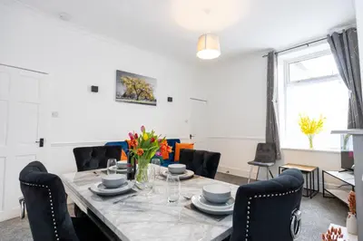 a dining room with a table and chairs at Cosy Four Bedroom Terrace Rishton in Rishton