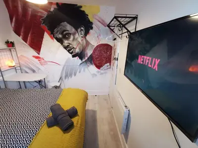 a bedroom with a movie poster on the wall at Unique LFC Themed House in Liverpool