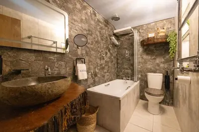 a bathroom with a sink and a tub and a toilet at The Bolt Hole in Morecambe