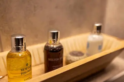 two bottles of soap sitting on a wooden shelf at The Bolt Hole in Morecambe