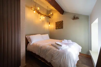 a bedroom with a bed with two towels on it at The Bolt Hole in Morecambe