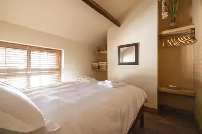 a bedroom with a white bed with towels on it at The Bolt Hole in Morecambe