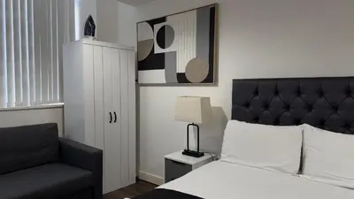 a bedroom with a bed and a chair at The Strand, Studio - Pass the Keys in Liverpool