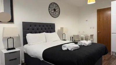 a bedroom with a large bed with towels on it at The Strand, Studio - Pass the Keys in Liverpool