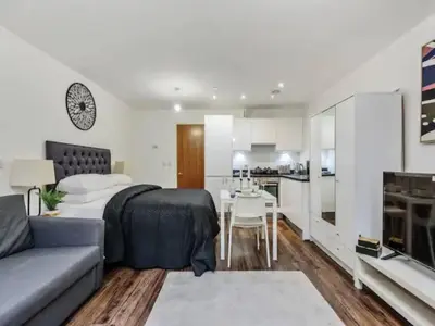 a living room with a couch and a kitchen at The Strand, Studio - Pass the Keys in Liverpool