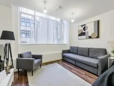 a living room with a couch and a chair at The Strand, Studio - Pass the Keys in Liverpool