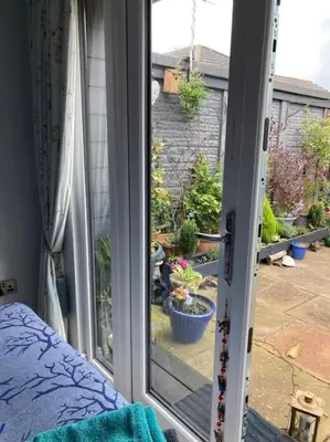 an open window with a view of a garden at Beautiful new Garden Annexe in Ashton in Makerfield