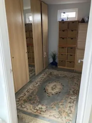 a room with a rug on the floor and an open door at Beautiful new Garden Annexe in Ashton in Makerfield