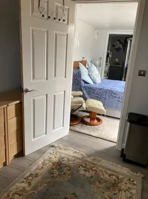 an open door to a bedroom with a bed at Beautiful new Garden Annexe in Ashton in Makerfield