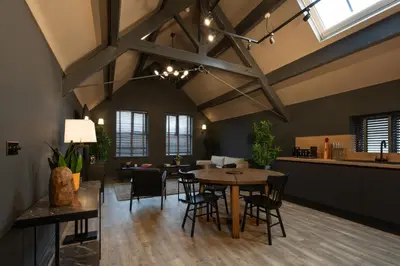a kitchen and dining room with a table and chairs at Lord Street Lofts in Southport