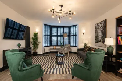 a living room with a couch and chairs at Lord Street Lofts in Southport