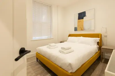 a bedroom with a bed with towels on it at Lord Street Lofts in Southport