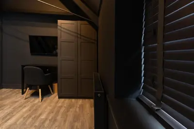 a room with a door and a chair and a table at Lord Street Lofts in Southport