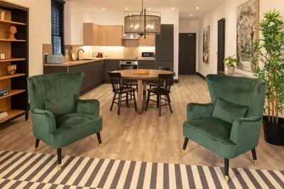 a kitchen and living room with a table and chairs at Lord Street Lofts in Southport