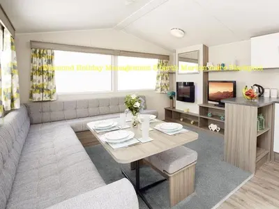 a living room with a table and a couch at Caravan Marton Mere Blackpool in Weeton