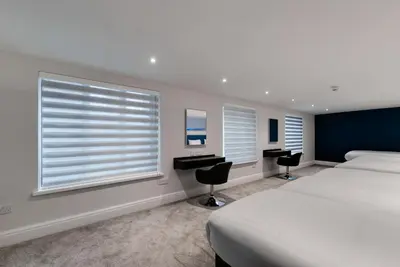 a bedroom with a bed and a desk and a window at Temple Court Cavern Quarter Apartments by Happy Days in Liverpool
