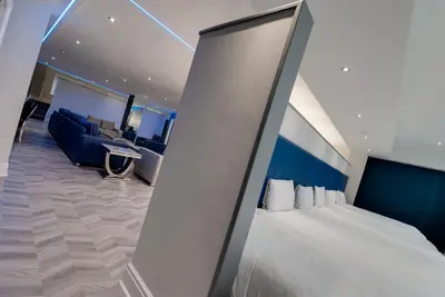 a hotel room with a bed and a couch at Temple Court Cavern Quarter Apartments by Happy Days in Liverpool