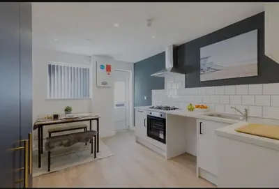 a kitchen with a sink and a stove at The Residency rooms Liverpool in Wallasey