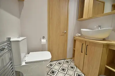 a bathroom with a white toilet and a sink at Pendle View Retreat - Holiday Park in Clitheroe