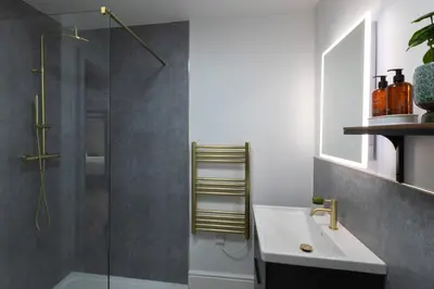 a bathroom with a glass shower and a sink at Winckley Chambers in Preston