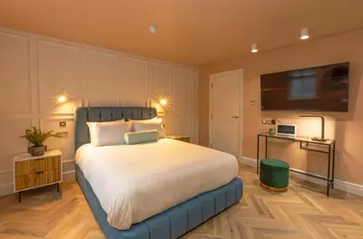 a bedroom with a large bed and a flat screen tv at Winckley Chambers in Preston
