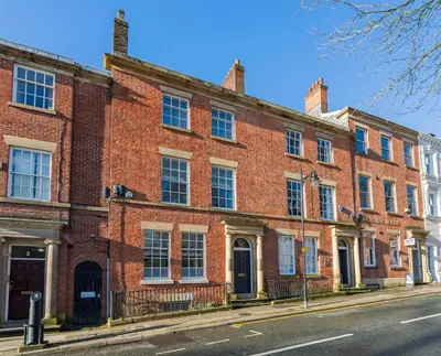 a large brick building on the side of a street at Winckley Chambers in Preston