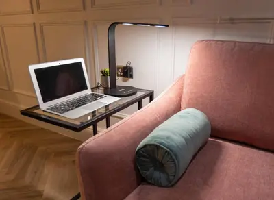 a laptop computer sitting on a table next to a couch at Winckley Chambers in Preston