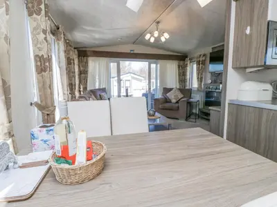a kitchen with a table with a basket on it at Lakeside Haven in Carnforth