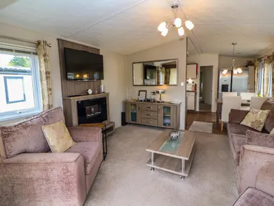 a living room with two couches and a table at Lakeside Haven in Carnforth