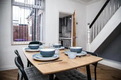 a dining room table with bowls and plates on it at Reduced Price, Long or Short Stays, Free Parking in Liverpool