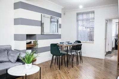 a living room with a couch and a table at Reduced Price, Long or Short Stays, Free Parking in Liverpool