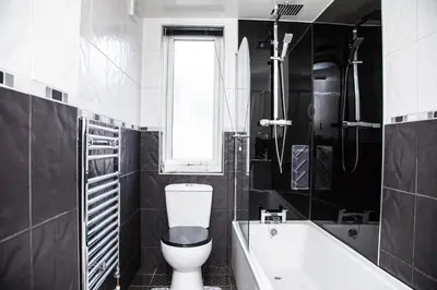 a bathroom with a toilet and a tub and a window at Reduced Price, Long or Short Stays, Free Parking in Liverpool