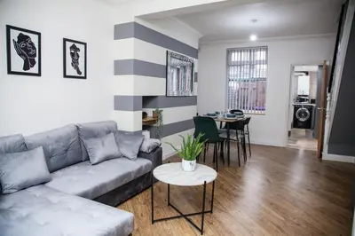 a living room with a couch and a table at Reduced Price, Long or Short Stays, Free Parking in Liverpool