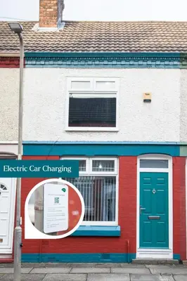 a red and white building with a green door at Reduced Price, Long or Short Stays, Free Parking in Liverpool