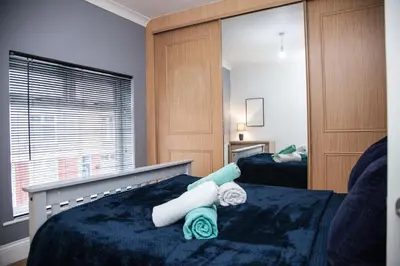 a bedroom with two beds with towels on them at Reduced Price, Long or Short Stays, Free Parking in Liverpool