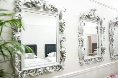 two mirrors on a white wall in a bathroom at Liverpool Georgian Quarter Townhouse Rodney St in Liverpool