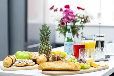 a table with a tray of bread and other foods at Liverpool Georgian Quarter Townhouse Rodney St in Liverpool