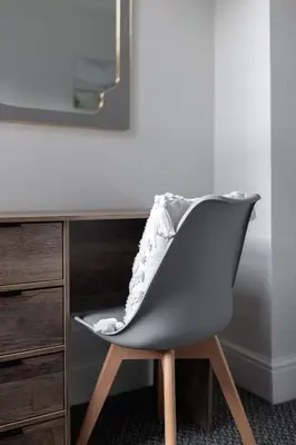 a chair sitting next to a desk with a mirror at Newcombe House - Air Host & Stay - Free Parking - Contractor Friendly in Liverpool
