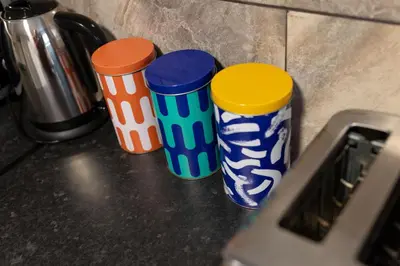 three colorful cups sitting on top of a counter at Newcombe House - Air Host & Stay - Free Parking - Contractor Friendly in Liverpool