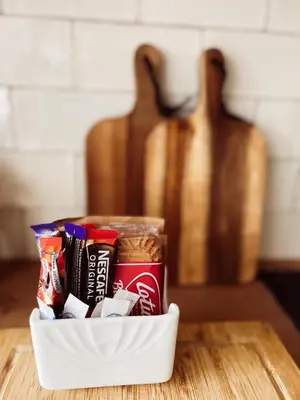 a container filled with snacks on a table at Holly Cottage in Cartmel