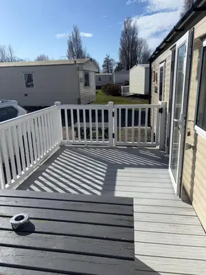 a wooden porch with a white fence on a house at McCanns Caravan Marton Mere in Blackpool