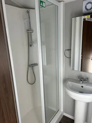 a bathroom with a shower and a sink at McCanns Caravan Marton Mere in Blackpool