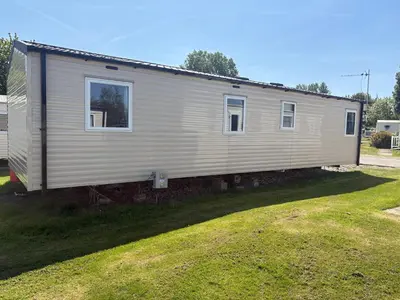 a mobile home sitting on top of a grass field at McCanns Caravan Marton Mere in Blackpool