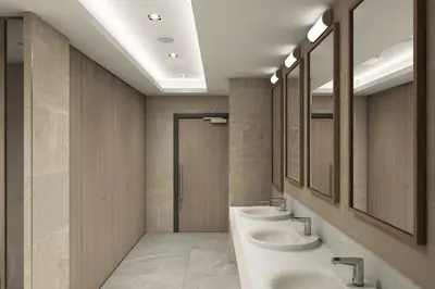 a bathroom with three sinks and a row of mirrors at Maldron Hotel Liverpool City Centre in Liverpool