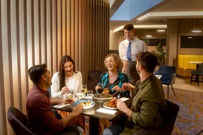 a group of people sitting around a table eating at Maldron Hotel Liverpool City Centre in Liverpool