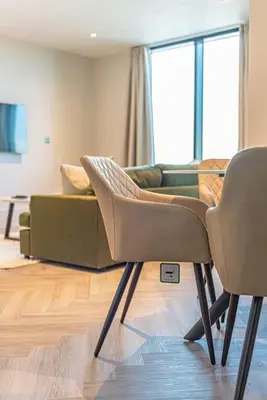 a living room with two chairs and a couch at 2BR Apt - Balcony - River View in Liverpool