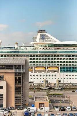 a large cruise ship parked in front of a parking lot at 2BR Apt - Balcony - River View in Liverpool