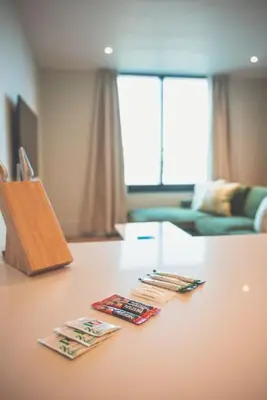 a table with three magazines on top of it at 2BR Apt - Balcony - River View in Liverpool