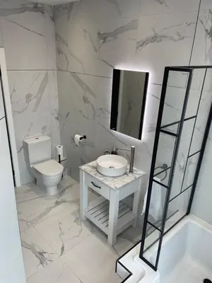 a bathroom with a sink and a toilet and a mirror at East Cliff in Preston