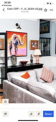 a room with a couch and a painting of an elephant at East Cliff in Preston